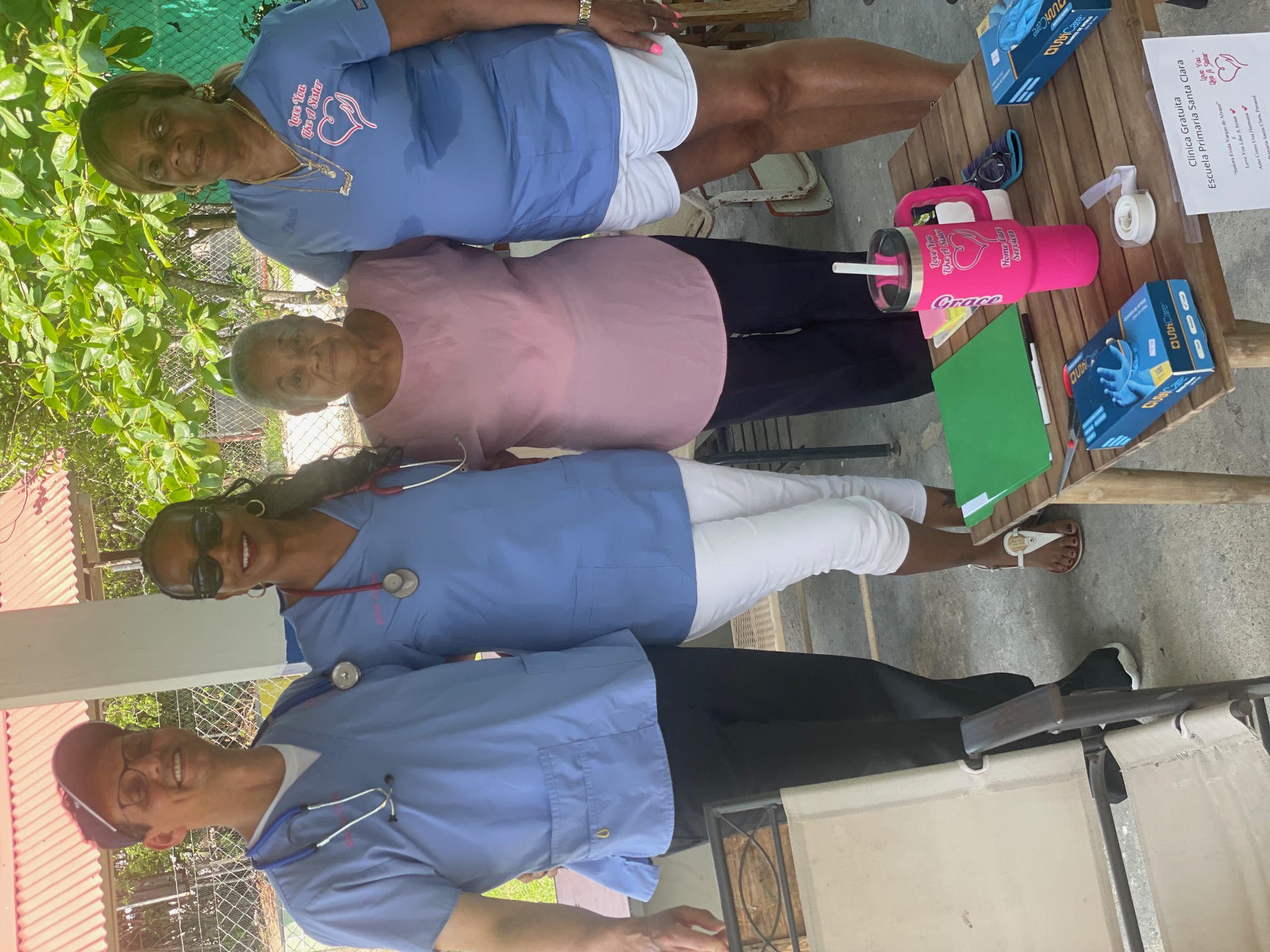 Caregivers standing with senior community member