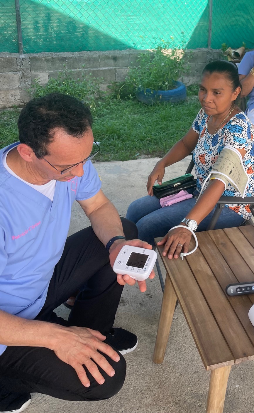 Caregiver performing blood pressure screening